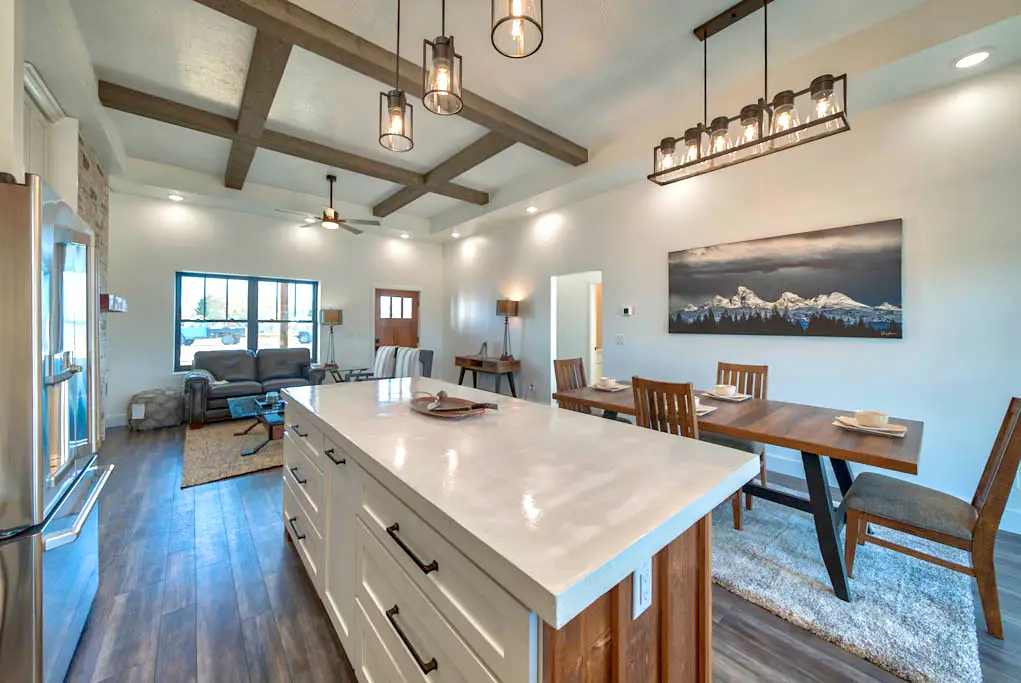 Interior photo of open-floor kitchen, dining, and living room in Powell, Wyoming built and designed by Harvell Homes