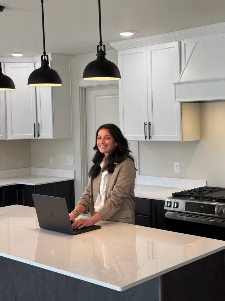 Cassidy Stanfield, interior designer, stands in kitchen designed and built by Harvell Homes