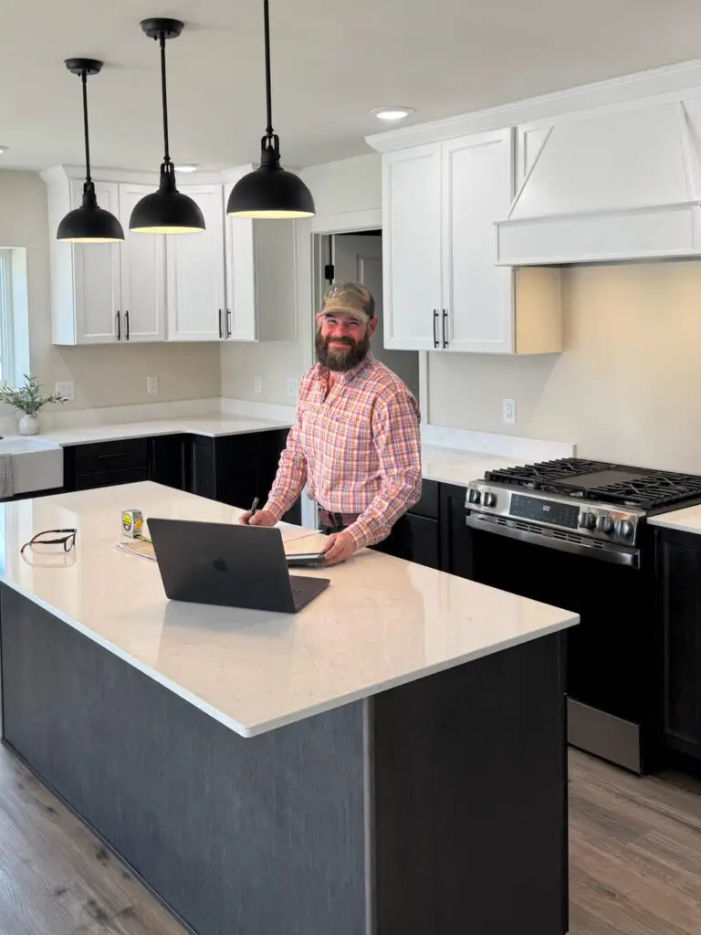 Trent Urwiller, field supervisor, stands in kitchen designed and built by Harvell Homes