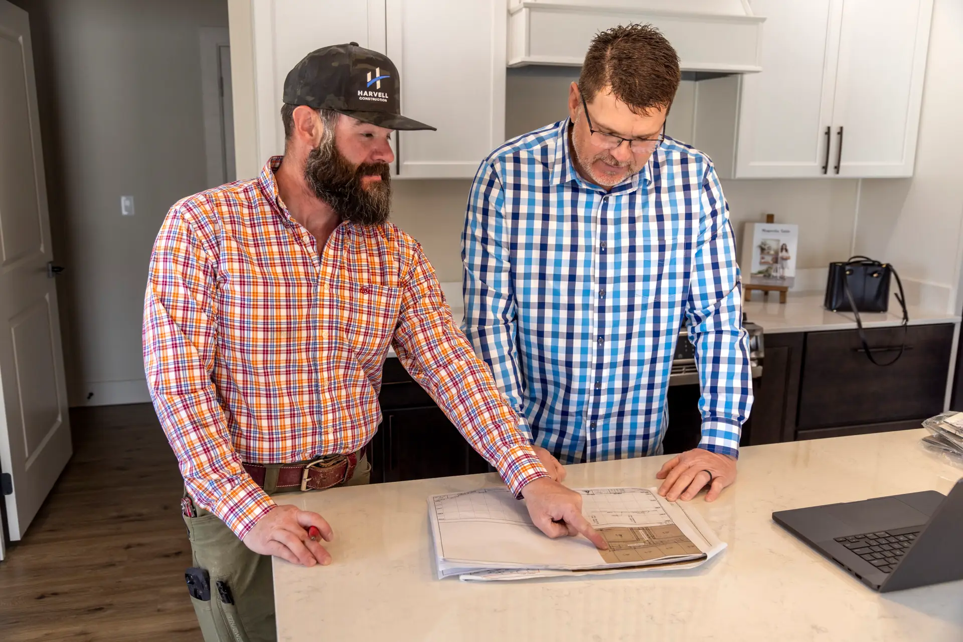 The Harvell team reviews plans for a custom home.