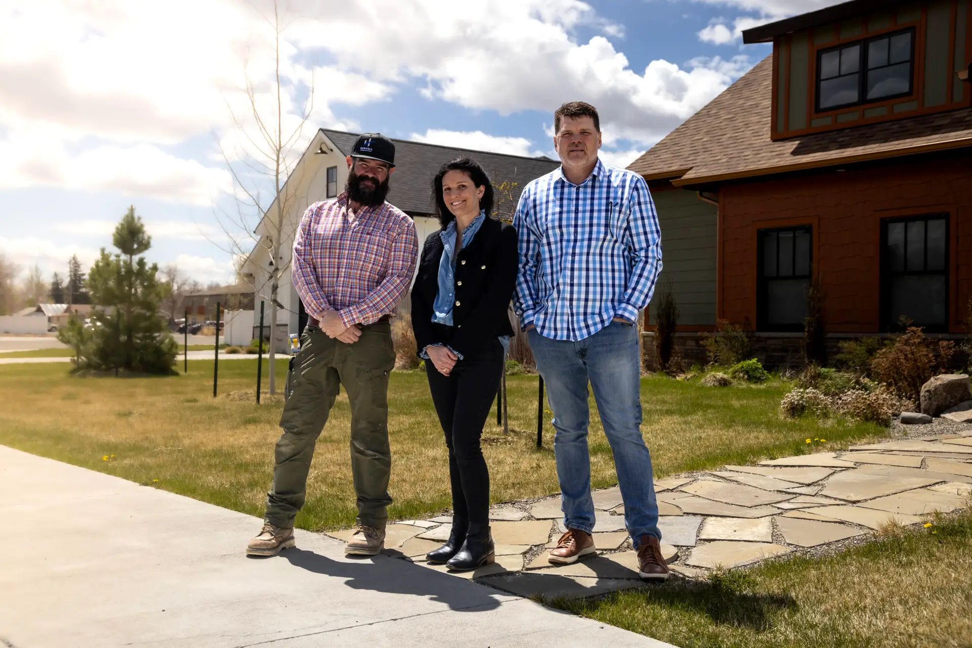 The Harvell team stands in front of homes they've completed in the Cottonwood Village Subdivision.
